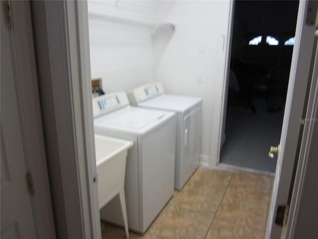 laundry room featuring independent washer and dryer, washer hookup, and light tile flooring