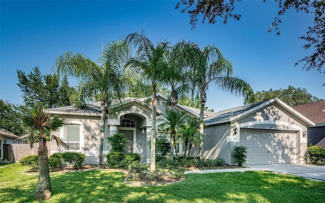 ranch-style home featuring a front lawn and a garage