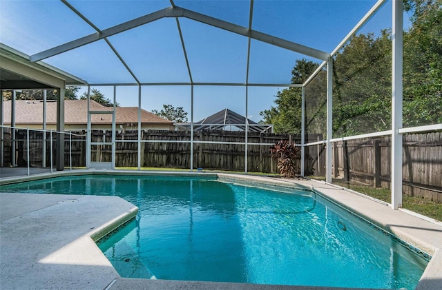 view of swimming pool featuring a lanai