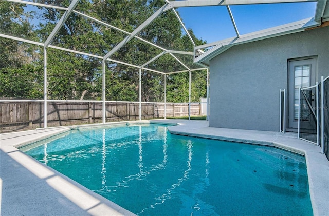 view of pool with a patio and glass enclosure