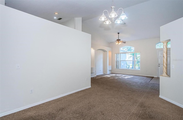 carpeted spare room featuring vaulted ceiling and ceiling fan with notable chandelier