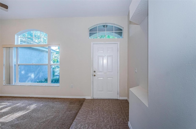 entryway featuring dark tile floors