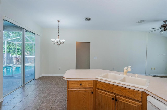 kitchen featuring decorative light fixtures, ceiling fan with notable chandelier, white dishwasher, sink, and light tile floors