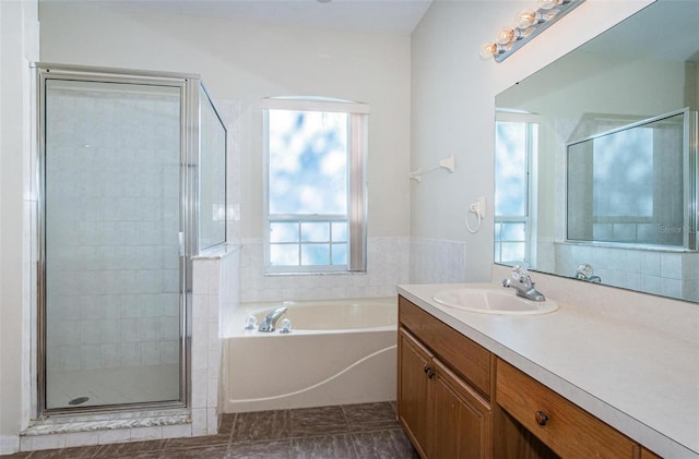 bathroom with tile flooring, vanity, and plus walk in shower