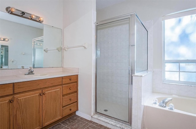 bathroom with tile floors, vanity, and shower with separate bathtub