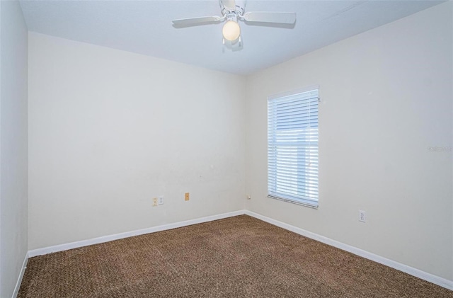 carpeted spare room featuring ceiling fan