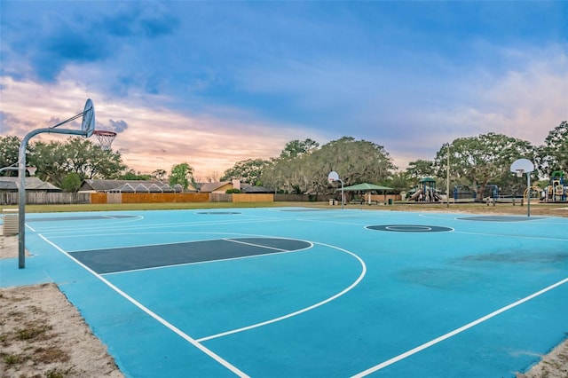 view of basketball court with a playground