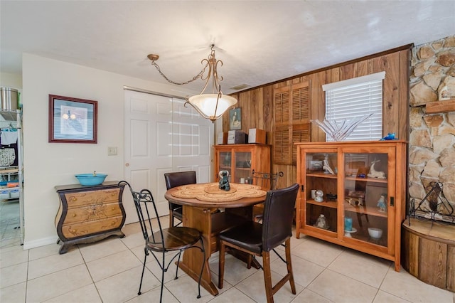 tiled dining room with wooden walls