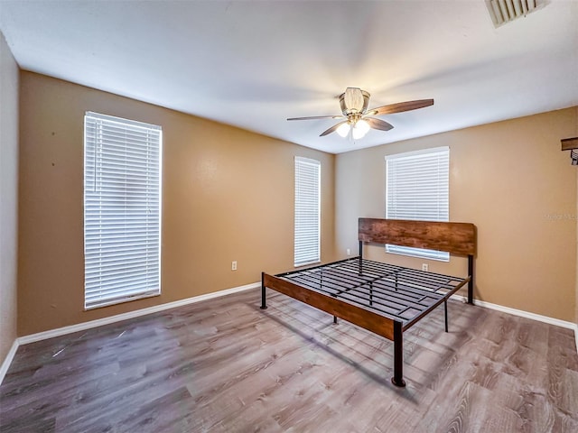 bedroom with wood-type flooring and ceiling fan