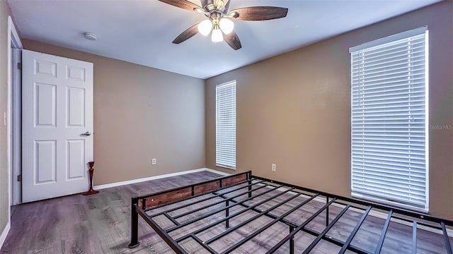 unfurnished bedroom featuring wood-type flooring and ceiling fan