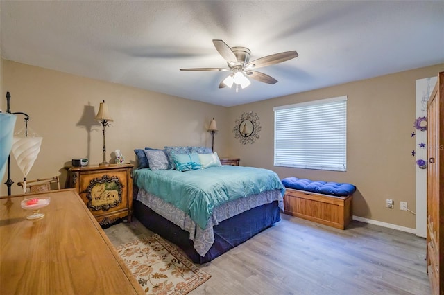 bedroom featuring light hardwood / wood-style floors and ceiling fan