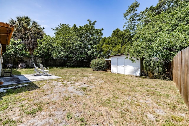 view of yard with a storage shed and a fire pit