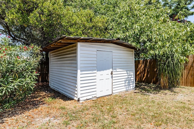 view of outbuilding featuring a yard