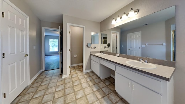 bathroom featuring double sink, tile floors, and large vanity