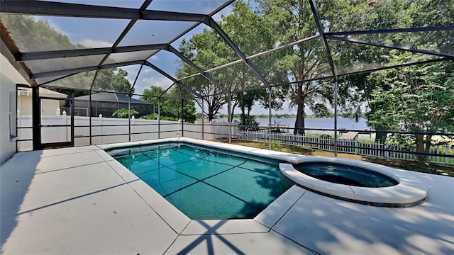 view of pool featuring a patio, a lanai, an in ground hot tub, and a water view