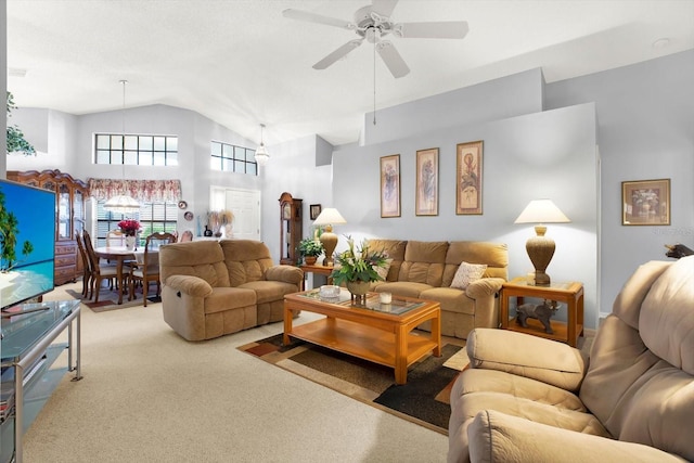 living room with carpet flooring, ceiling fan, and lofted ceiling