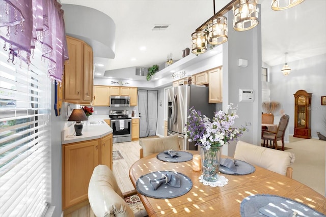 dining room with a chandelier and light hardwood / wood-style flooring