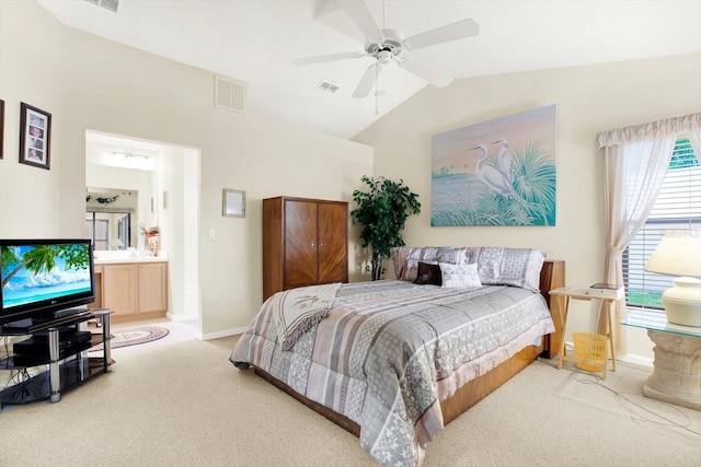 carpeted bedroom with ceiling fan, ensuite bathroom, and vaulted ceiling