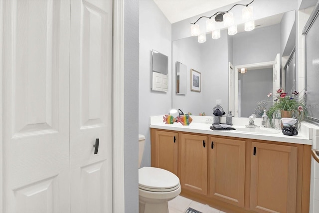 bathroom with tile floors, toilet, and vanity