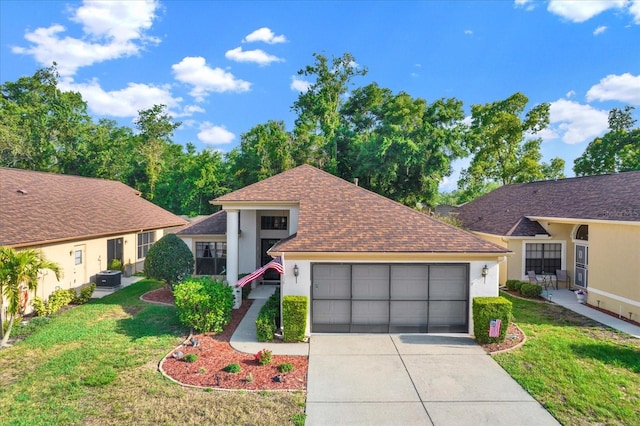 view of front of home featuring a front lawn and a garage