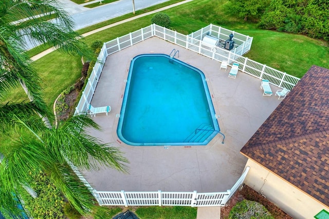 view of pool featuring a patio and a lawn