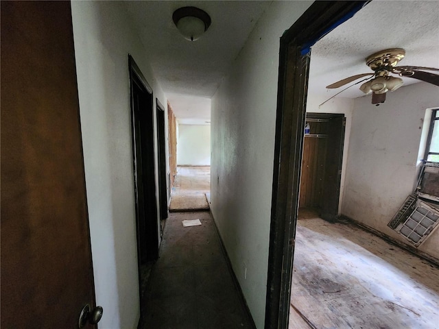 hall featuring a textured ceiling