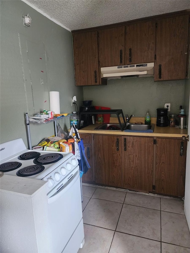 kitchen featuring light tile floors, sink, electric stove, and a textured ceiling