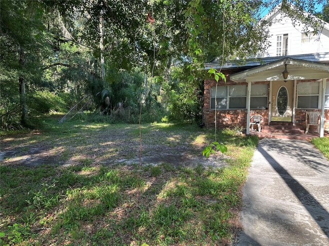 view of yard with covered porch