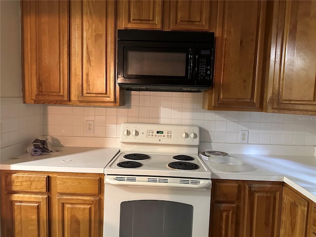 kitchen with white electric range oven and tasteful backsplash