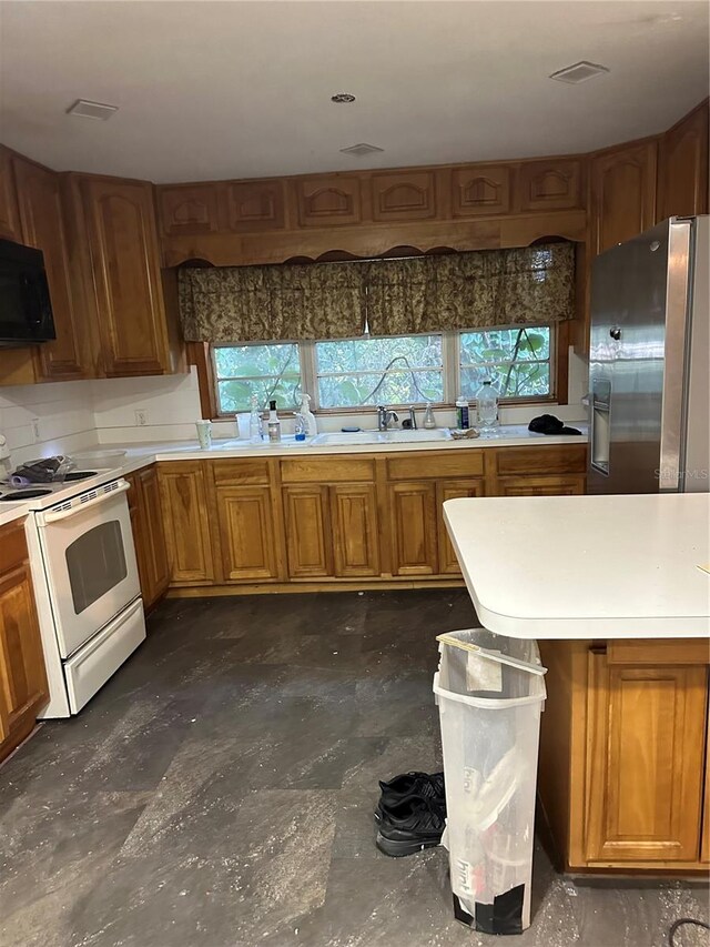 kitchen with gas range gas stove and stainless steel fridge with ice dispenser