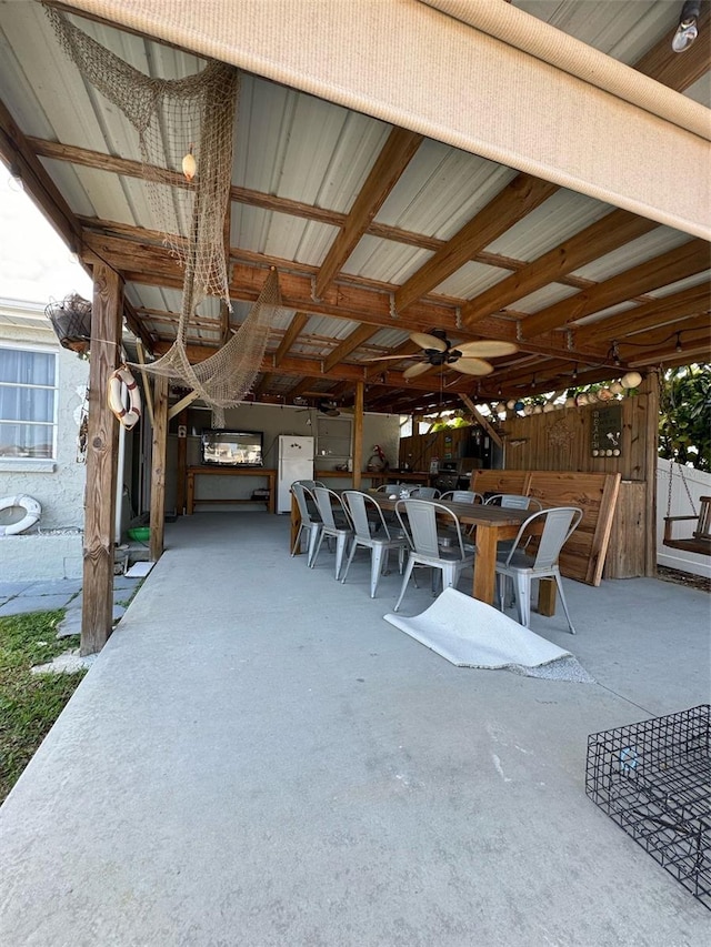 view of patio / terrace featuring an outdoor bar and ceiling fan