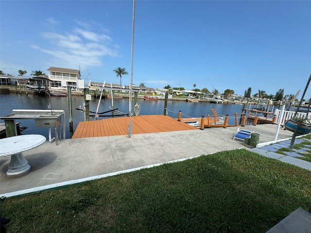 dock area featuring a water view and a yard