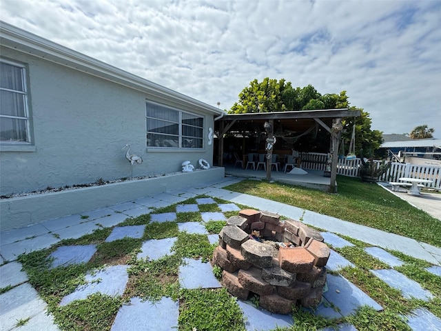 view of yard with a fire pit and a patio