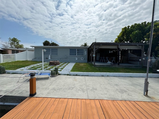 back of property with a lawn and a patio