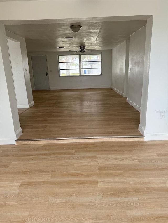 spare room featuring light hardwood / wood-style floors and ceiling fan