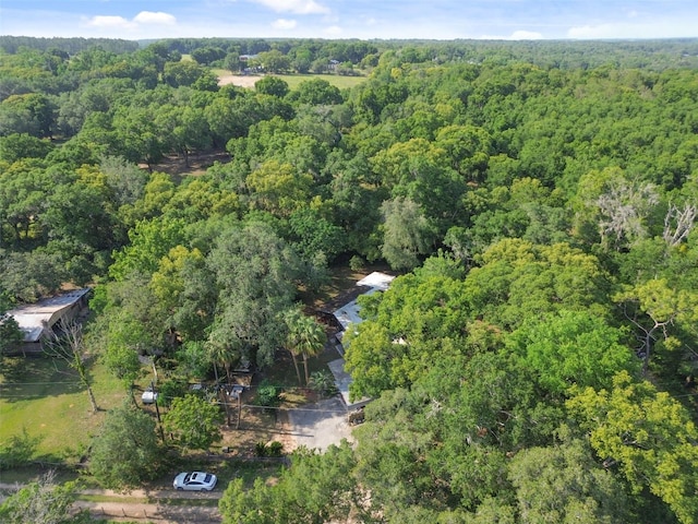 birds eye view of property featuring a wooded view