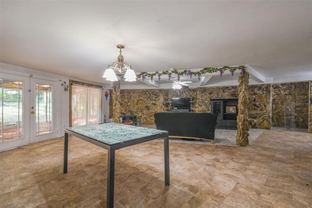 rec room with a chandelier and french doors