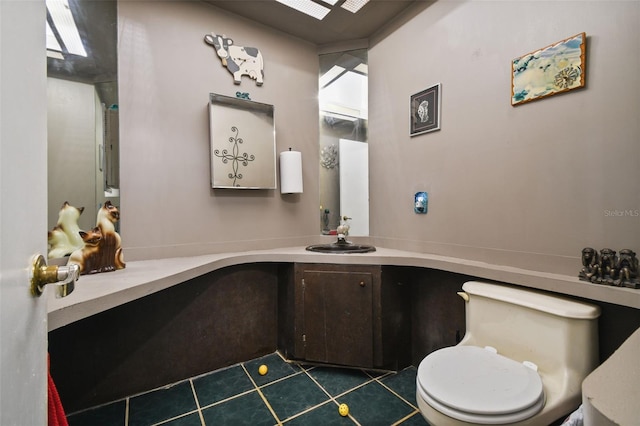 bathroom featuring toilet, tile patterned flooring, and vanity