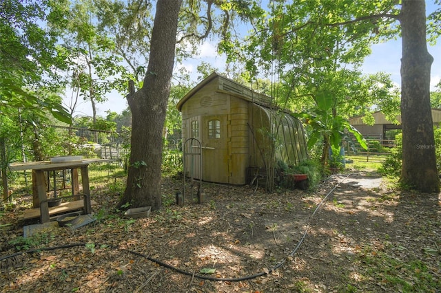 view of shed featuring fence