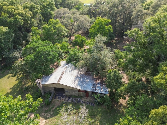 drone / aerial view with a wooded view