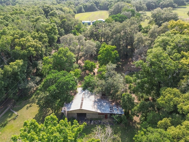 birds eye view of property featuring a wooded view