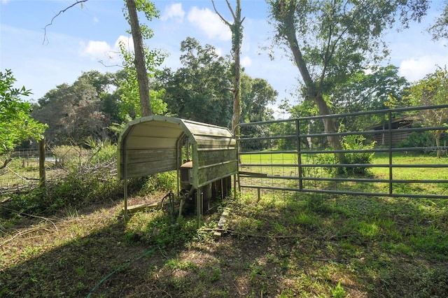 view of yard with fence and a detached carport