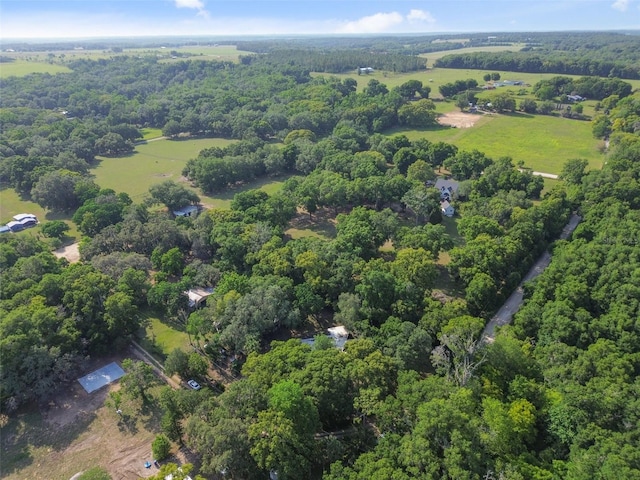 drone / aerial view featuring a wooded view