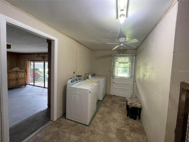 clothes washing area featuring a ceiling fan, plenty of natural light, laundry area, and separate washer and dryer