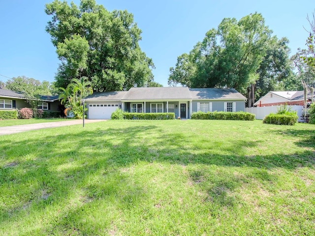 single story home featuring a garage and a front lawn