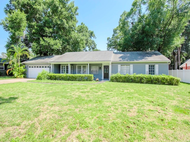 ranch-style house with a garage and a front lawn