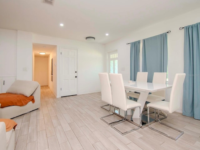 dining space with light hardwood / wood-style flooring