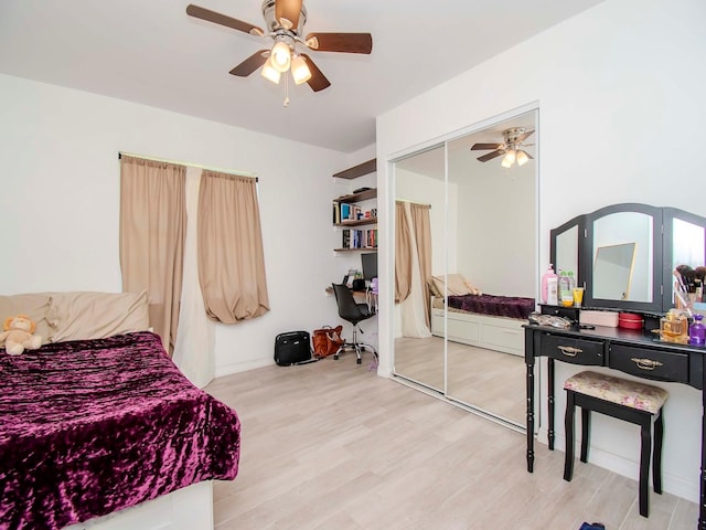 bedroom featuring ceiling fan, a closet, and light wood-type flooring