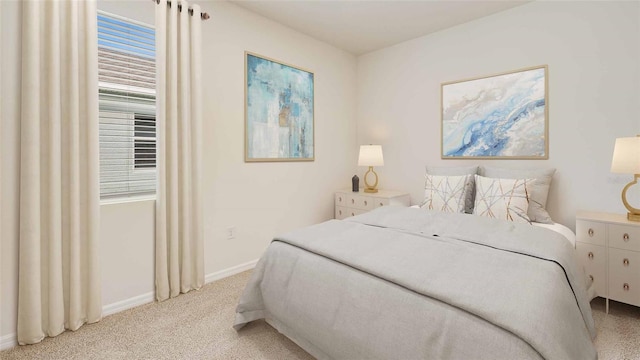 bedroom featuring light colored carpet