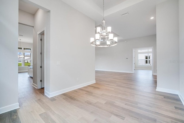 unfurnished room featuring recessed lighting, visible vents, light wood-style floors, a chandelier, and baseboards